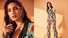 Nora Fatehi`s shiny pantsuit with a plunging neckline is every bit glam