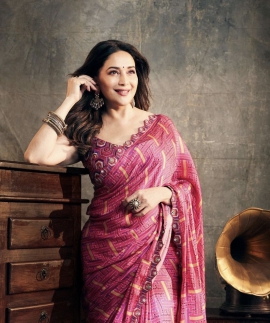 Madhuri Dixit in a Punit Balana saree proves it`s easy to go bright and pink this festive season; Yay or Nay?