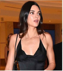 Kendall Jenner’s fitted black gown with sultry halter neckline is a masterclass in minimalistic elegance