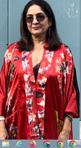 Neena Gupta in black lace dress layered with red floral robe and black boots proves that style has no age bar